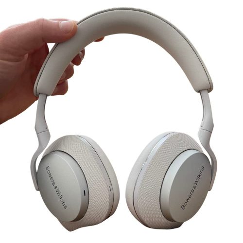 a hand holding a pair of white headphones