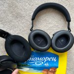 a pair of black headphones next to a yellow book