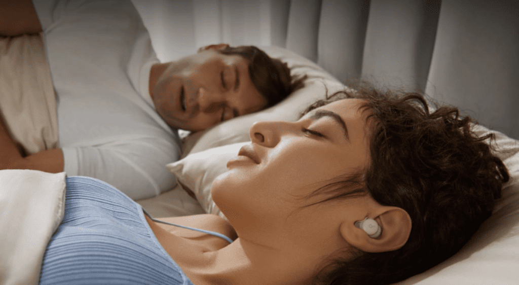 person sleeping peacefully while wearing small comfortable earbuds